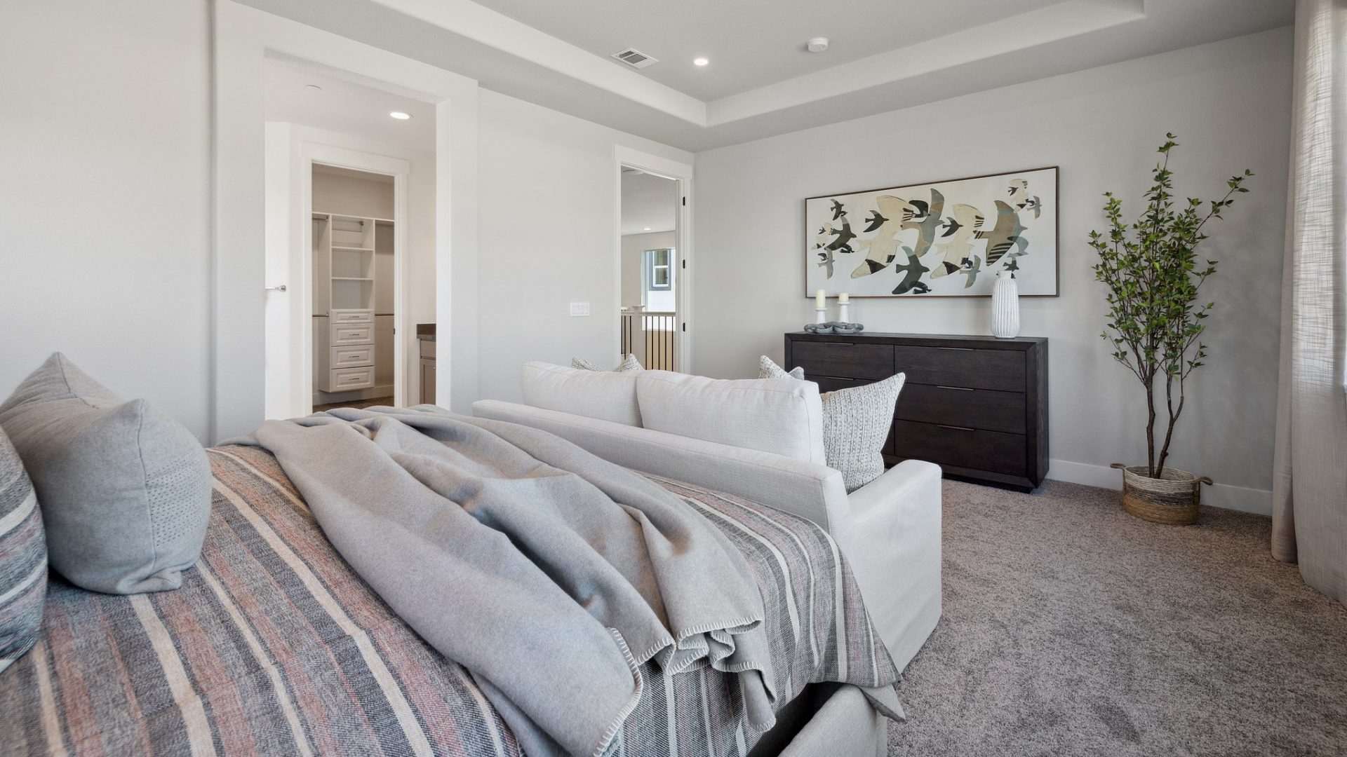 Carpeted bedroom with 9 foot recessed ceiling and canned lights, and 8 foot doorway to the hallway.