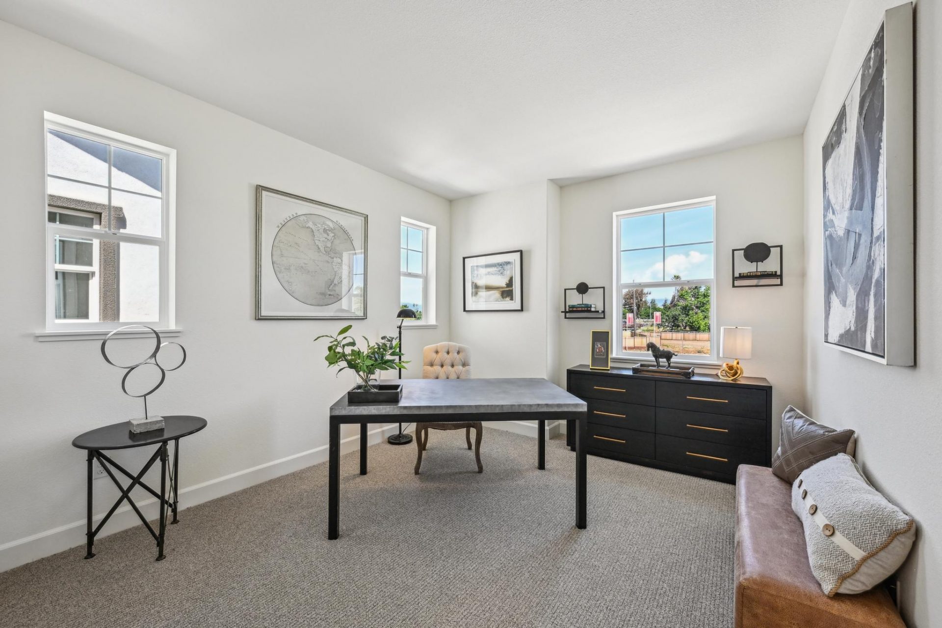 Carpeted upstairs landing that can be used as an office of media room with desk and padded bench, 3 large windows, and 9 foot ceilings.