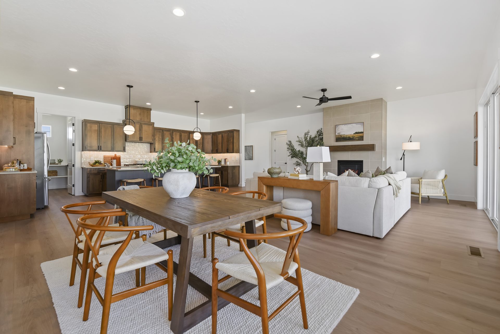 Open concept dining room, living room and kitchen layout with 9 foot ceilings, canned lights, electric fireplace and hard wood flooring.