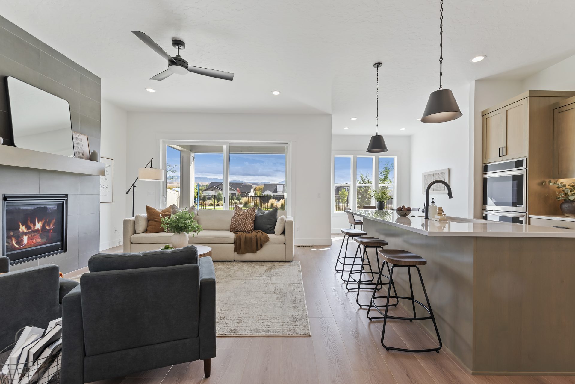 A view of the open concept space between the kitchen and the living room with a furnished seating area.