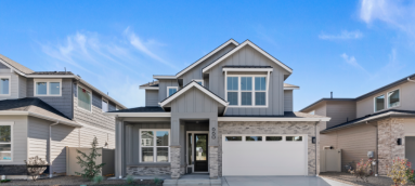 Two-story craftsman-style home with stone accents, three-car garage, and covered front porch.